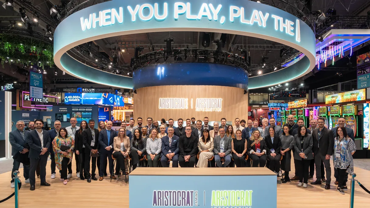 Group photo of the Aristocrat team at an exhibition booth